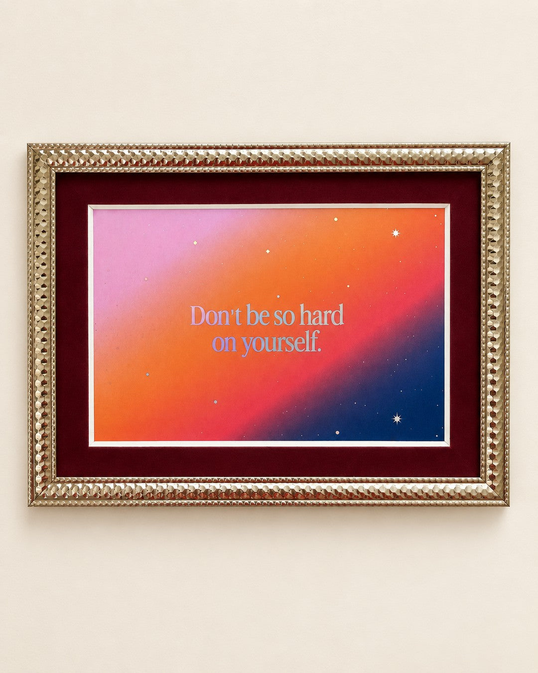 Iridescent text 'Don't be so hard on yourself' on a pink, orange and navy starry gradient